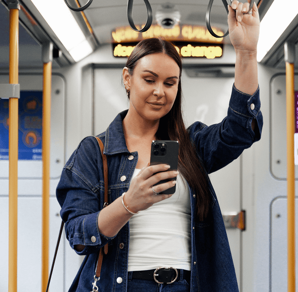 Woman on a train holding a phone